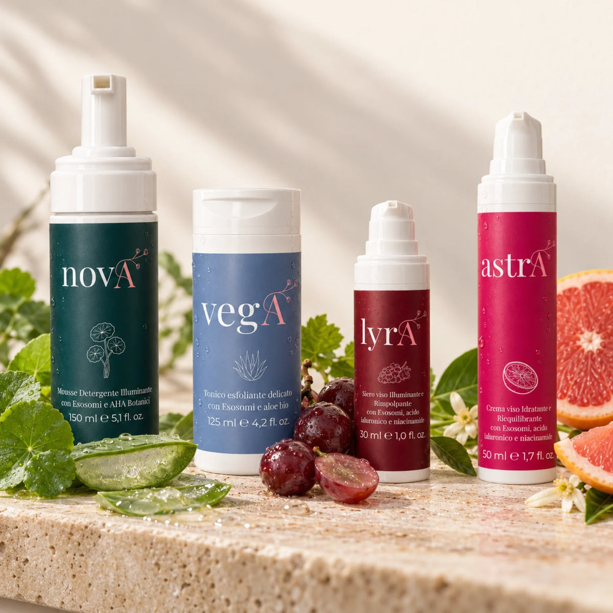 Quattro prodotti della Routine Completa Curamour con ingredienti botanici su travertino